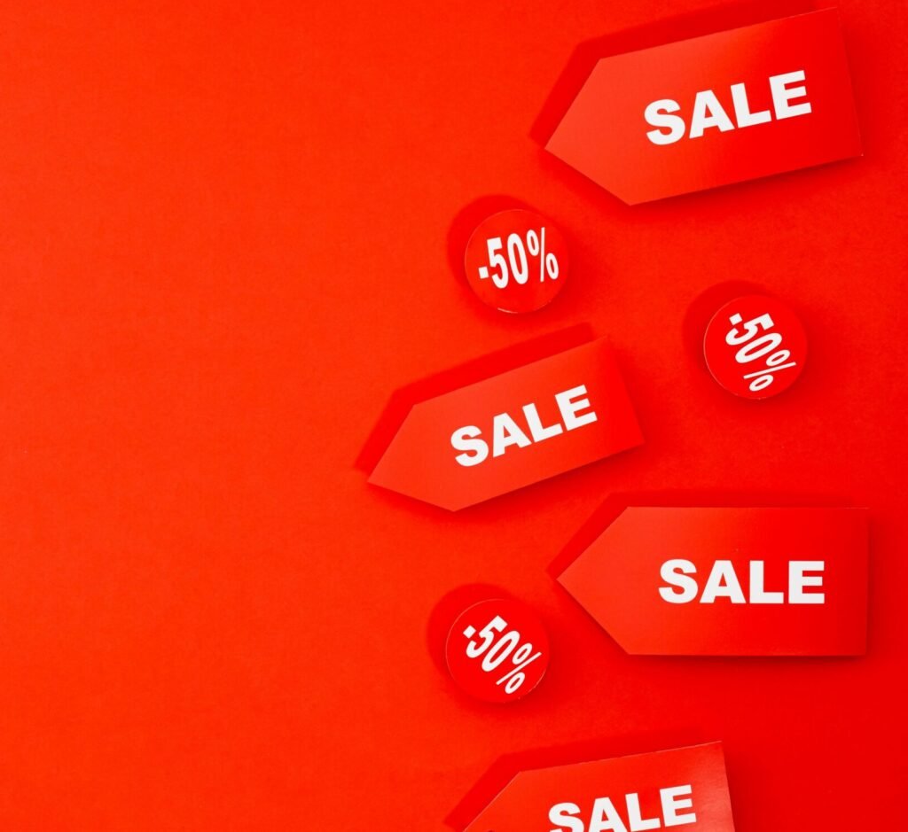 Red sale tags with 50% discounts on vibrant background for retail promotions.